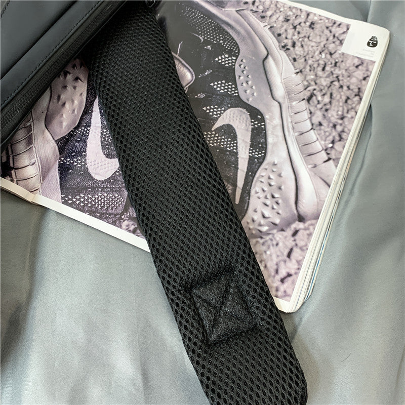 He+It+She Universal Crossbody bag adjustable black mesh strap close-up