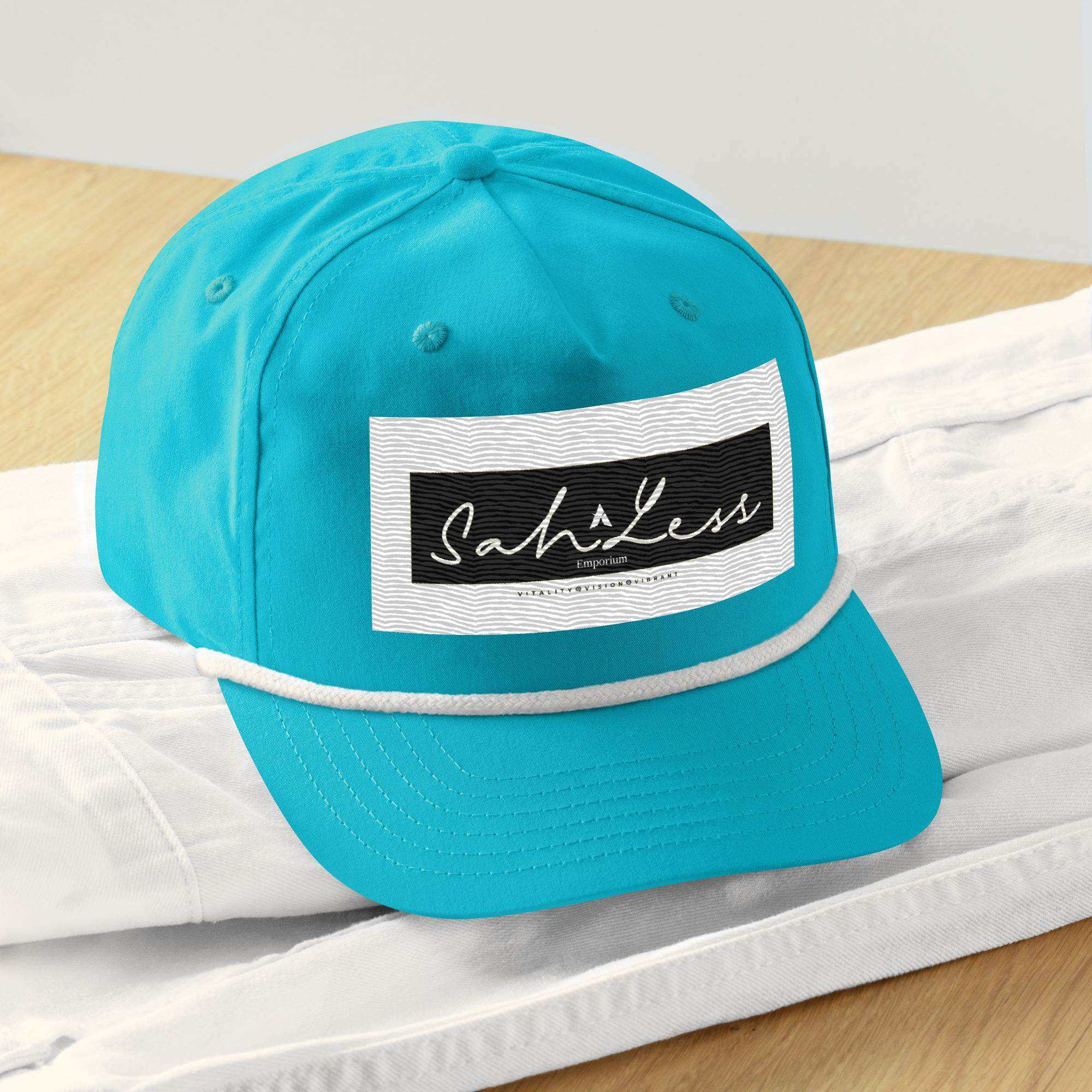 Turquoise snapback rope cap by SahLess Emporium on a wooden surface.