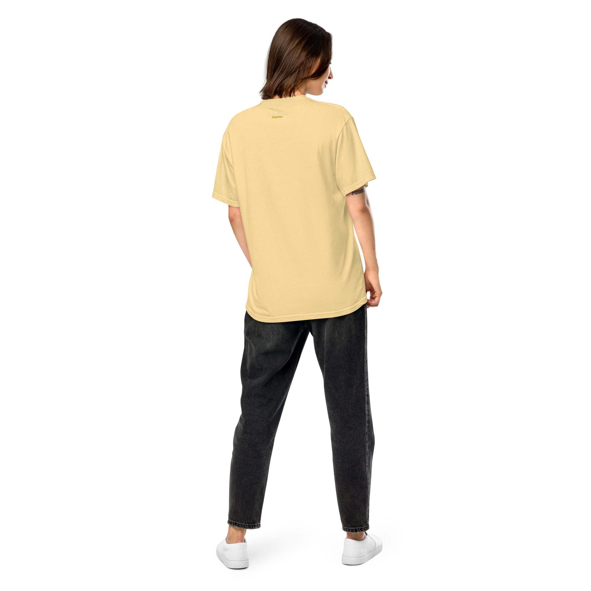 Unisex heavyweight t-shirt in yellow, worn by a person, showcasing relaxed fit and durable design.
