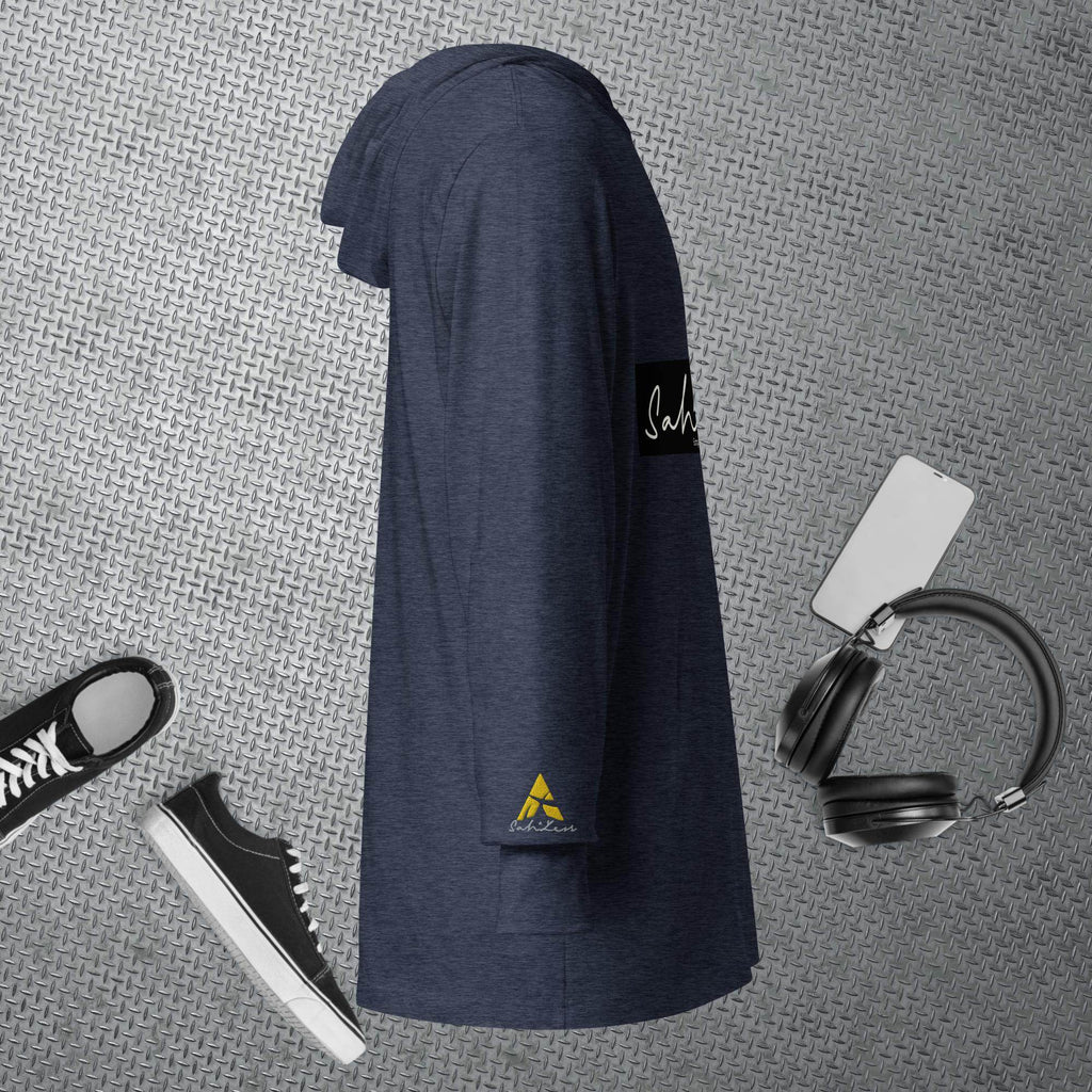 Hooded long-sleeve tee in navy blue on a textured background with sneakers, headphones, and smartphone accessories.