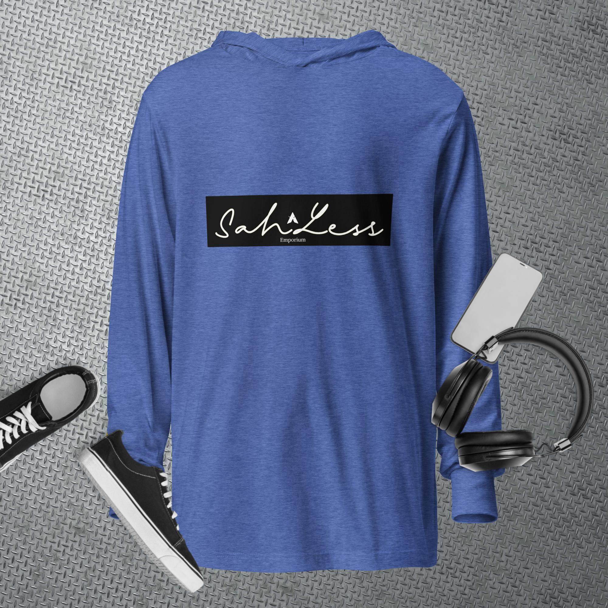 Hooded long-sleeve tee in blue with SahLess Emporium logo, surrounded by casual accessories like shoes and headphones.