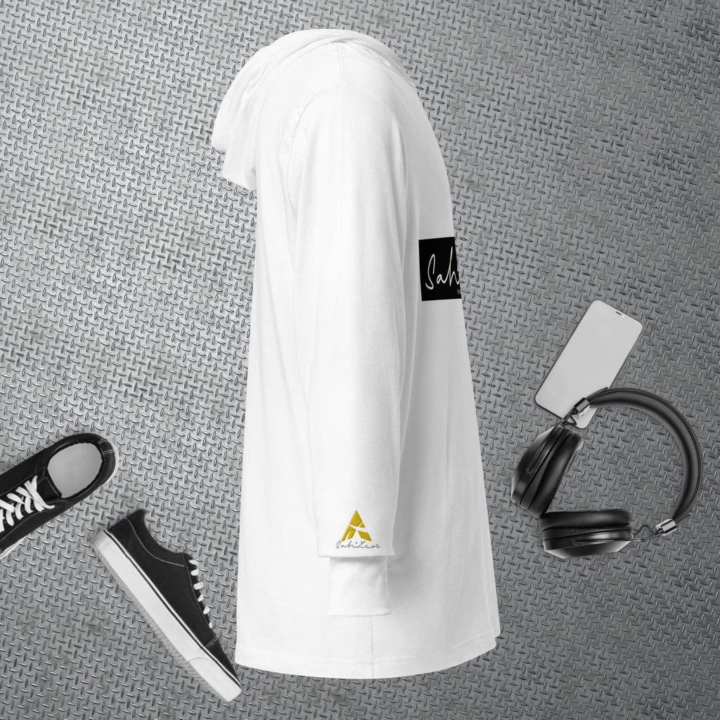 Hooded long-sleeve tee by SahLess Emporium in white, perfect for casual layering, shown with sneakers and headphones on a textured background.