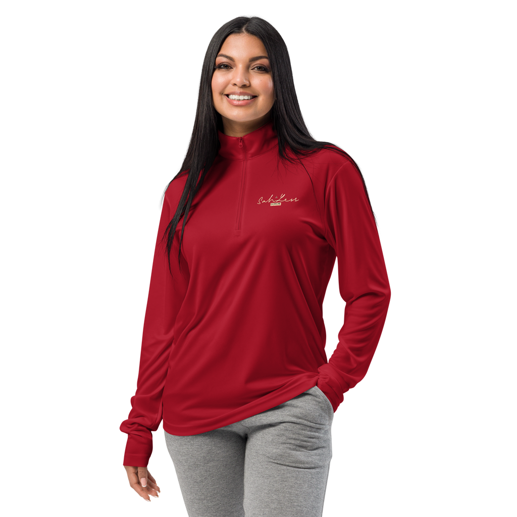 Woman wearing red lightweight quarter-zip pullover with cadet collar and grey pants