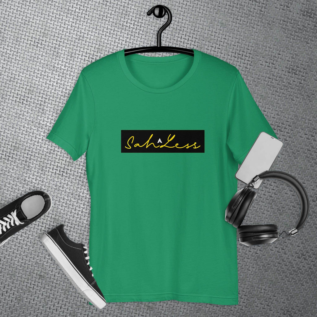 SahLess Signature Unisex T-shirt in green on hanger with sneakers and headphones nearby.