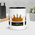 Mug with colorful crown design and black rim, SahLess Mug in kitchen setting.