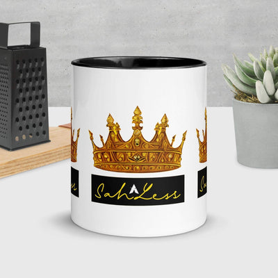 Mug with colorful crown design and black rim, SahLess Mug in kitchen setting.