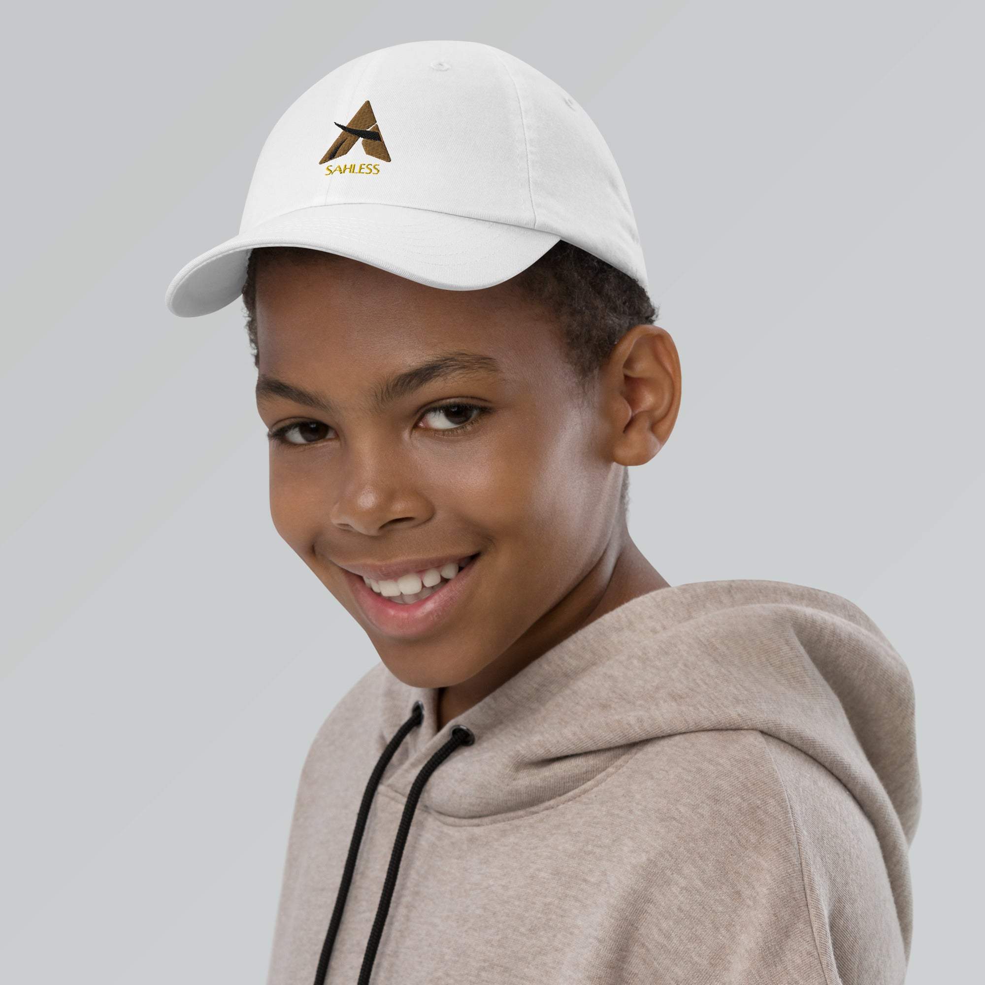 Youth wearing SahLess youth baseball cap with adjustable strap and pre-curved visor.