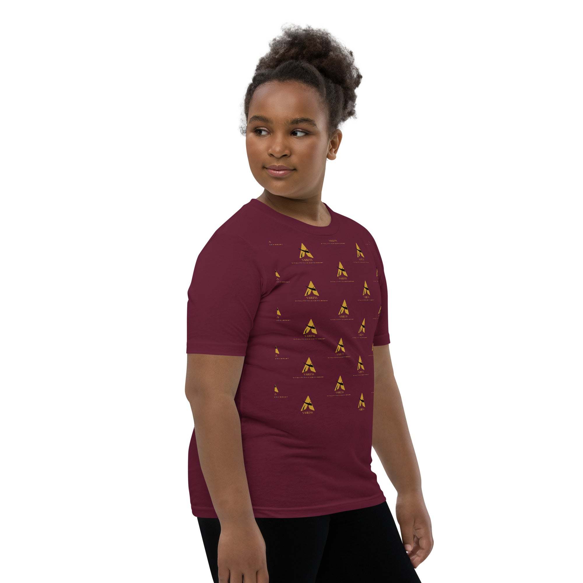 Youth wearing a SahLess Short Sleeve T-Shirt, featuring a unique design on a maroon background, made from soft cotton.